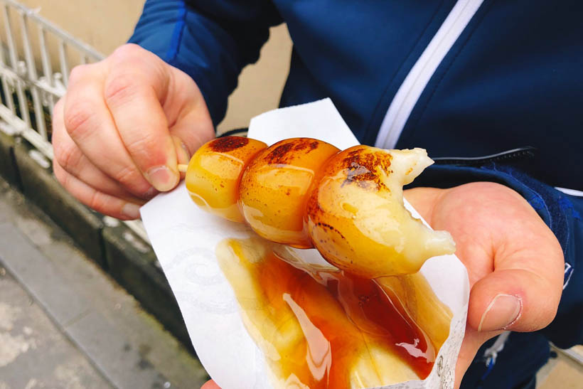 Dango balls, made with rice flour and covered with a sweet sauce, bought from a food stand near the Bamboo Grove in Arashiyama, Kyoto (Japan).