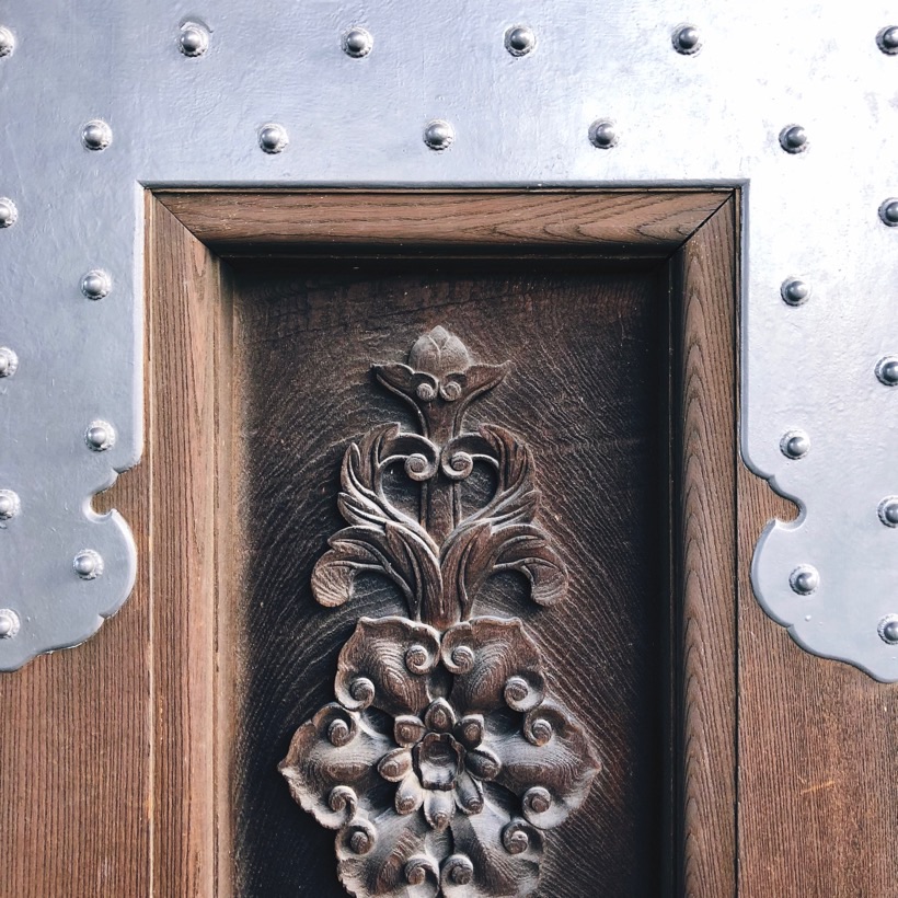 A wooden carving in on of the wooden entrance gates of Higashi Honganji temple in Kyoto, Japan.