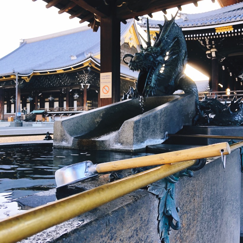 A statue of a dragon dispensing water at a purification fountain at Higashi Honganji temple in Kyoto, Japan.