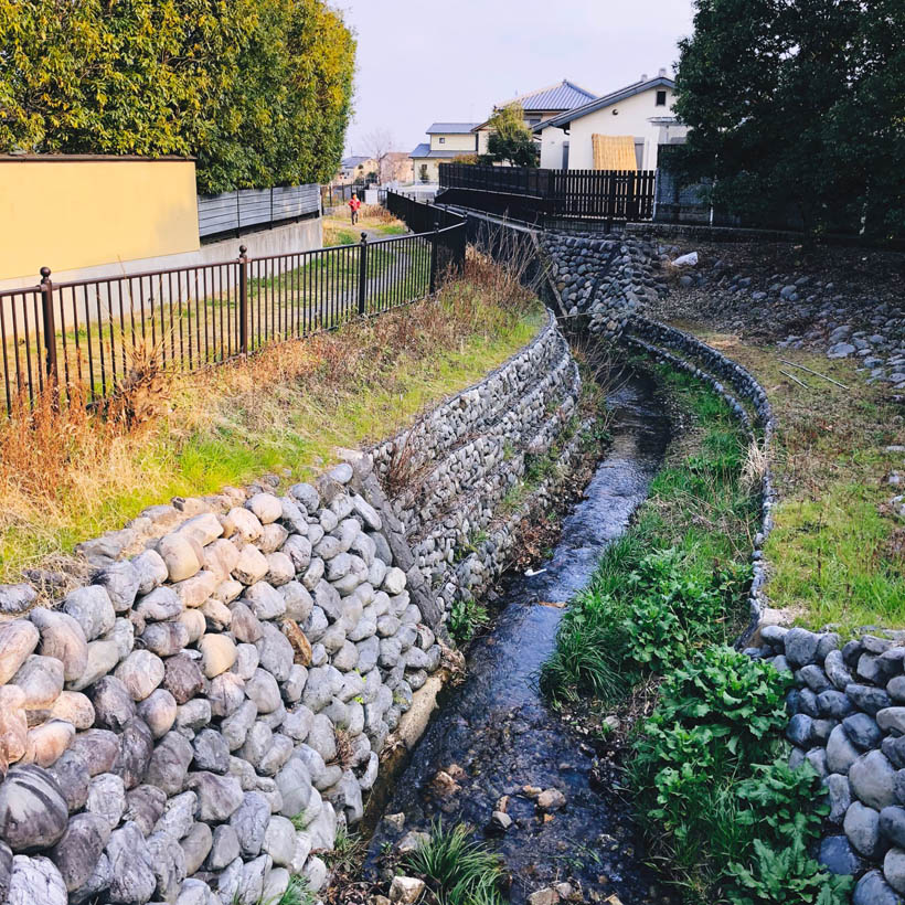 A small river in a residential area near Saga-Toriimoto in Kyoto, Japan.