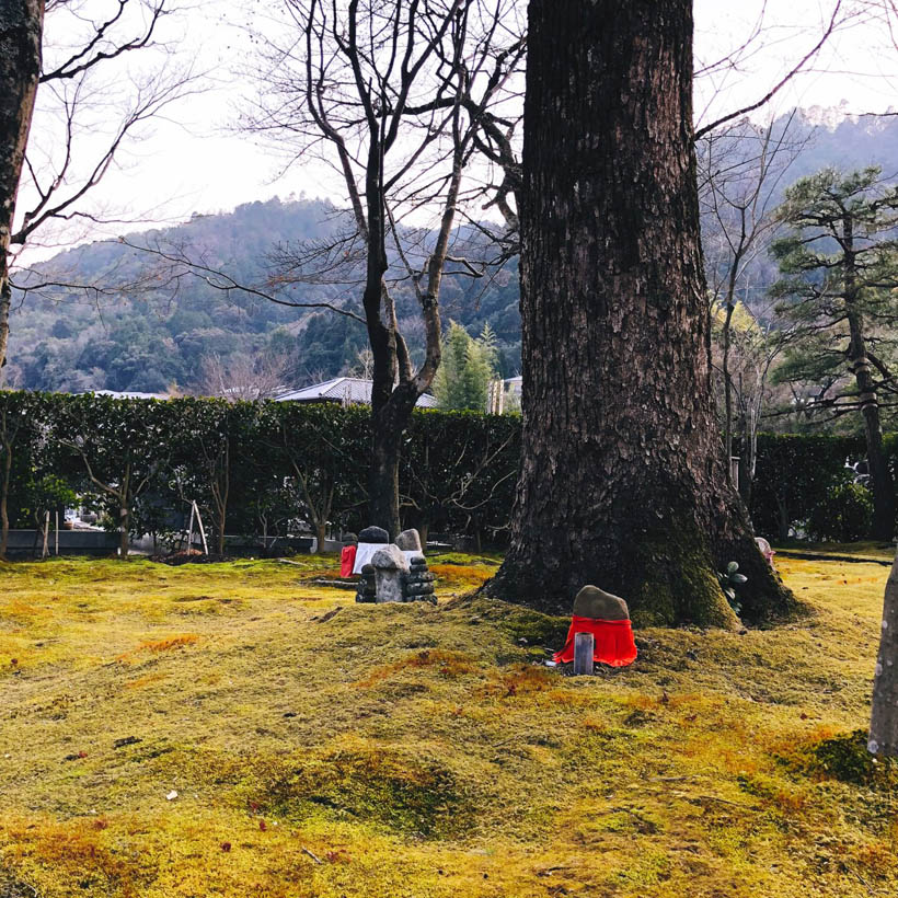 Statues at Adashino Nenbutsu-ju temple in Kyoto, Japan, dressed in red and white clothes.