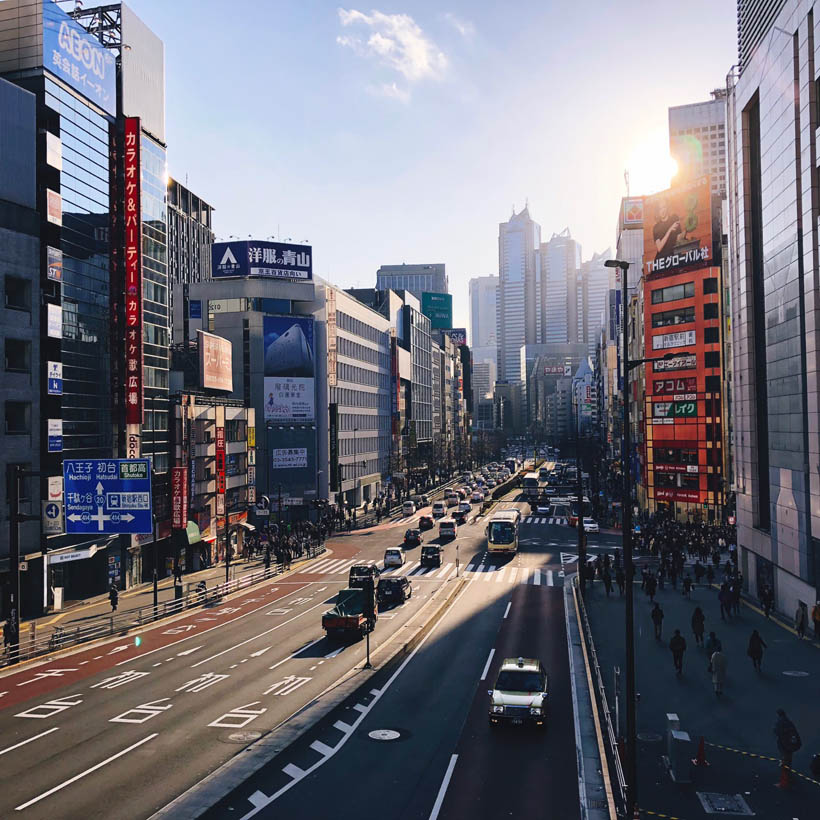 Looking over Koshu-kaido Ave in the afternoon from the bridge that connects the two main buildings of Shinjuku station in Tokyo, Japan.