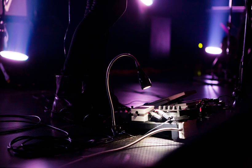 A small desk lamp shining on a pedal board at a concert of Man Without Country at the AB in Brussels, Belgium.
